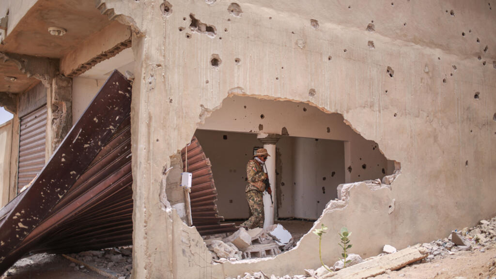 A soldier from the Front de Libération de l'Azawad (FLA) walks through a damaged building in Kidal on May 9, 2026.