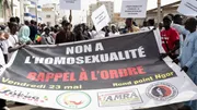 Protesters in Dakar hold signs reading 'No to homosexuality' during a demonstration calling for criminalization of LGBTQ+ identities in Senegal, May 23, 2025.