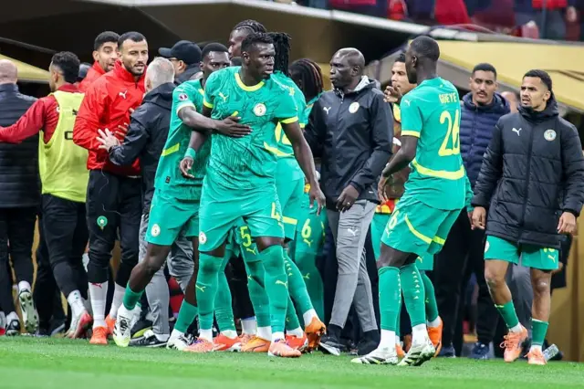 Senegalese players protesting a penalty decision during the CAN 2025 final
