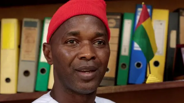 Close-up of Fernando Dias wearing a red hat