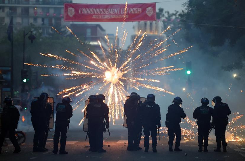Fireworks light up the sky as police move in during celebrations in Paris