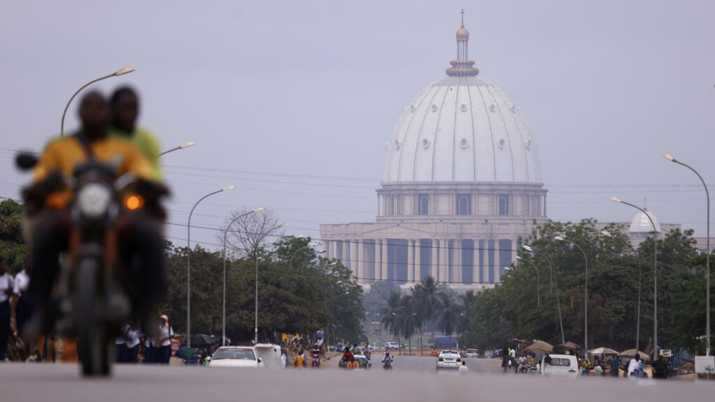 Aerial view of Yamoussoukro's Notre Dame de la Paix basilica, showcasing the city's urban expansion