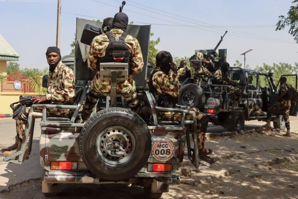 Nigerian soldiers prepare to patrol during the visit of Nigeria's Chief of Defence Staff General Olufemi Oluyede at the Headquarters Theatre Command Joint Task Force in Maiduguri on March 18, 2026 after one of the deadliest attacks in the Borno state capital in years. The triple suicide bombing on March 16, 2026 in Maiduguri killed 23 people.
