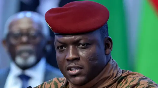 Captain Ibrahim Traoré in military attire, speaking during a televised address