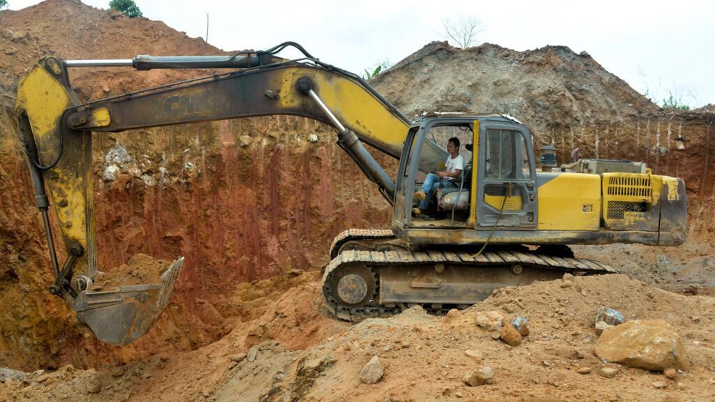 A Chinese employee operates a bulldozer at a mining site in Betare Oya, Cameroon, April 4, 2018.