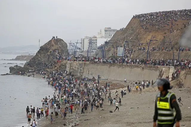 Migrants near the Moroccan border with Ceuta attempting to cross into Spanish territory