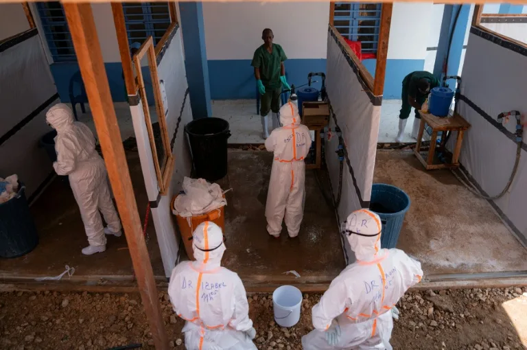 Healthcare workers in protective gear administering care during an Ebola response