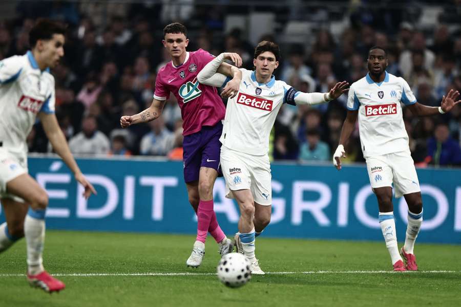 Rasmus Nicolaisen challenges Leonardo Balerdi during the Coupe de France quarter-final between Marseille and Toulouse at Stade Vélodrome on March 4, 2026